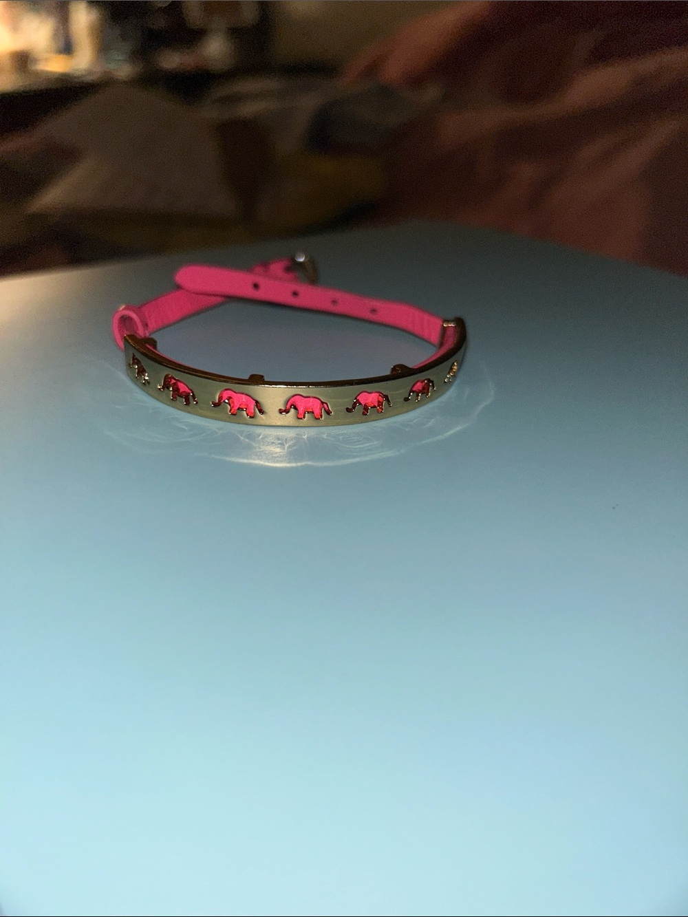 Gold-tone Bangle Bracelet with Pink Elephant Accents